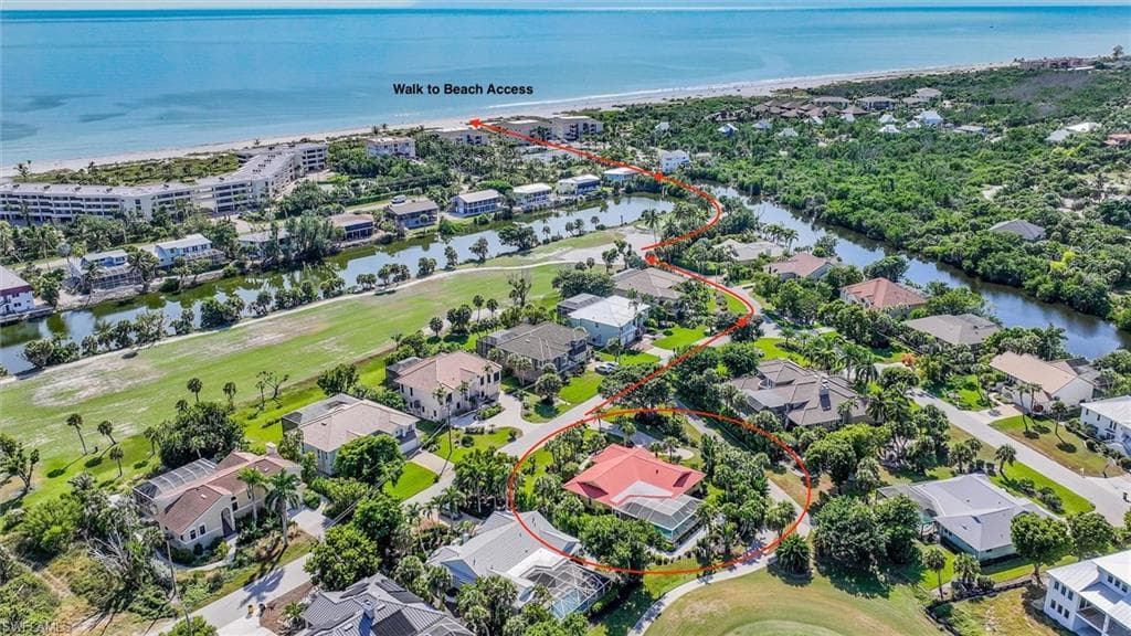 Aerial view of residential area with a golf club and a nearby body of water