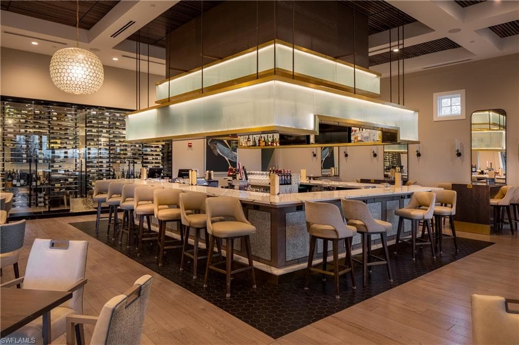 Bar area with a high ceiling and decorative light fixtures