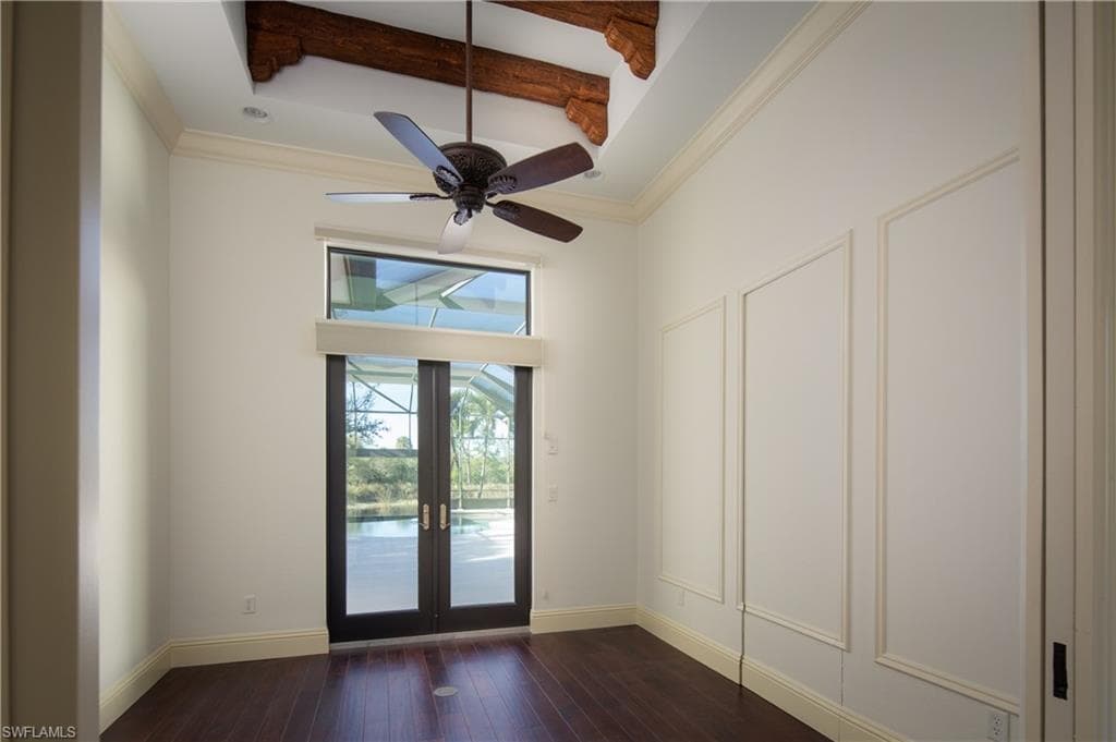 Doorway featuring beamed ceiling, ornamental molding, french doors, a ceiling fan, and hardwood / wood-style floors