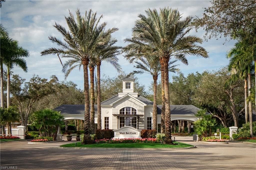 View of property featuring decorative driveway