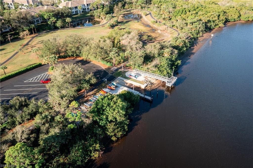 Aerial view of property and surrounding area with a large body of water
