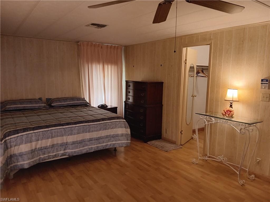Living room featuring wood finished floors and a ceiling fan
