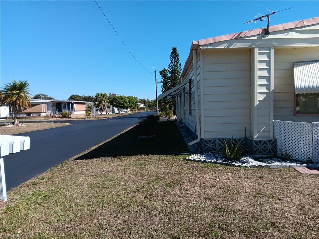View of asphalt road featuring a residential view