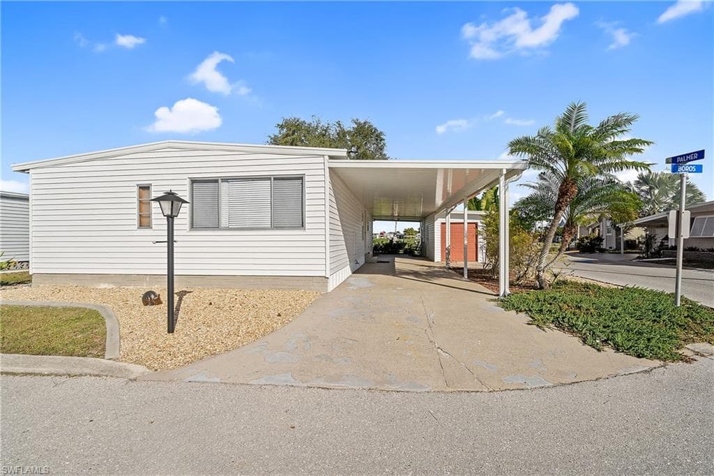 Manufactured / mobile home with a carport and concrete driveway