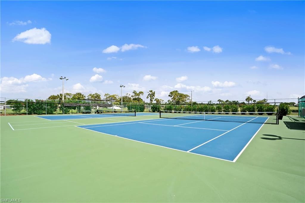 View of tennis court with community basketball court