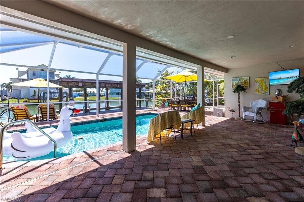 Pool with a lanai and a patio area