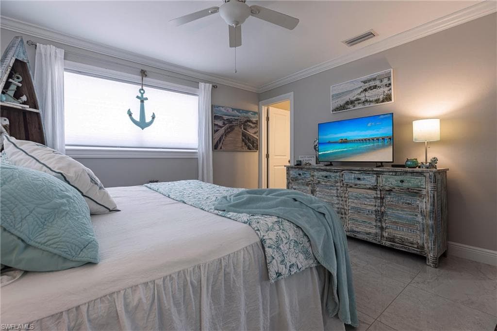Bedroom with crown molding, marble finish floor, baseboards, and ceiling fan