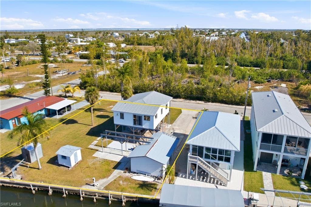Rear of property with 3 sheds and additional lot