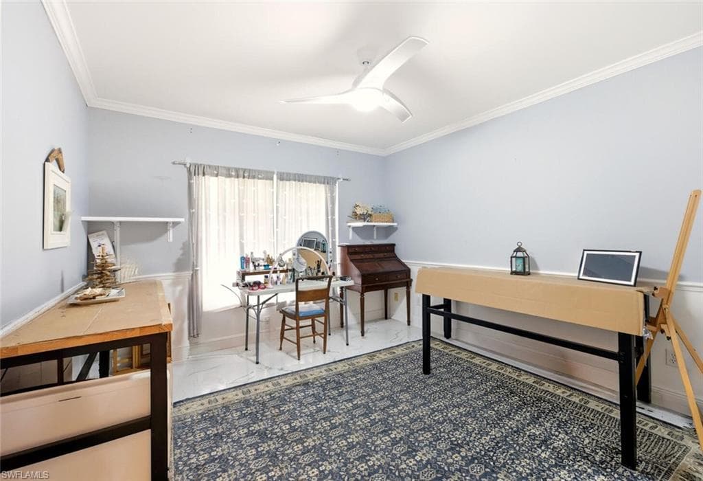 Office with ceiling fan and ornamental molding