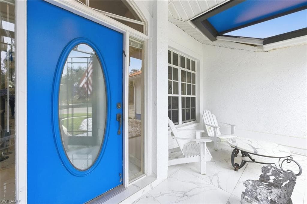Entrance to property with stucco siding