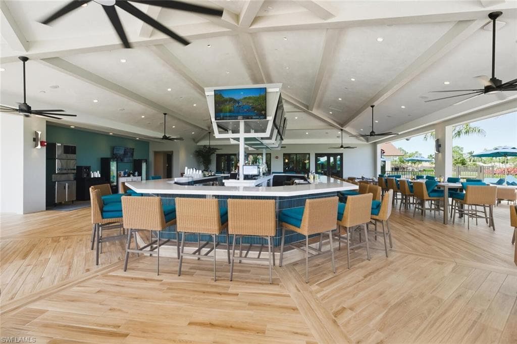 Kitchen with open floor plan, recessed lighting, beamed ceiling, a ceiling fan, and light countertops