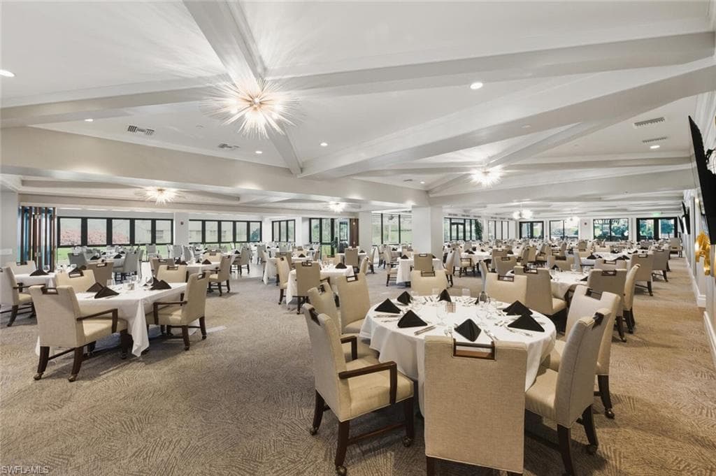 Dining area with carpet floors, recessed lighting, plenty of natural light, beamed ceiling, and crown molding