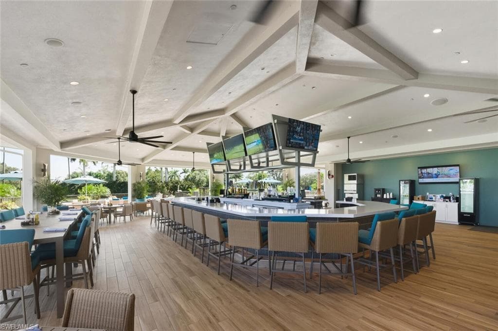 Bar area featuring ceiling fan, recessed lighting, and beam ceiling