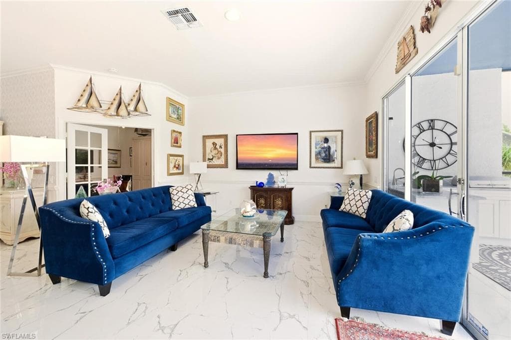 Living room with crown molding and marble finish floors