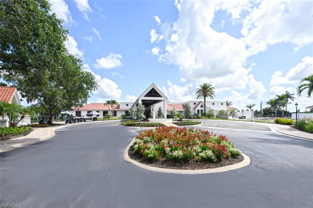 View of asphalt road featuring sidewalks and curbs