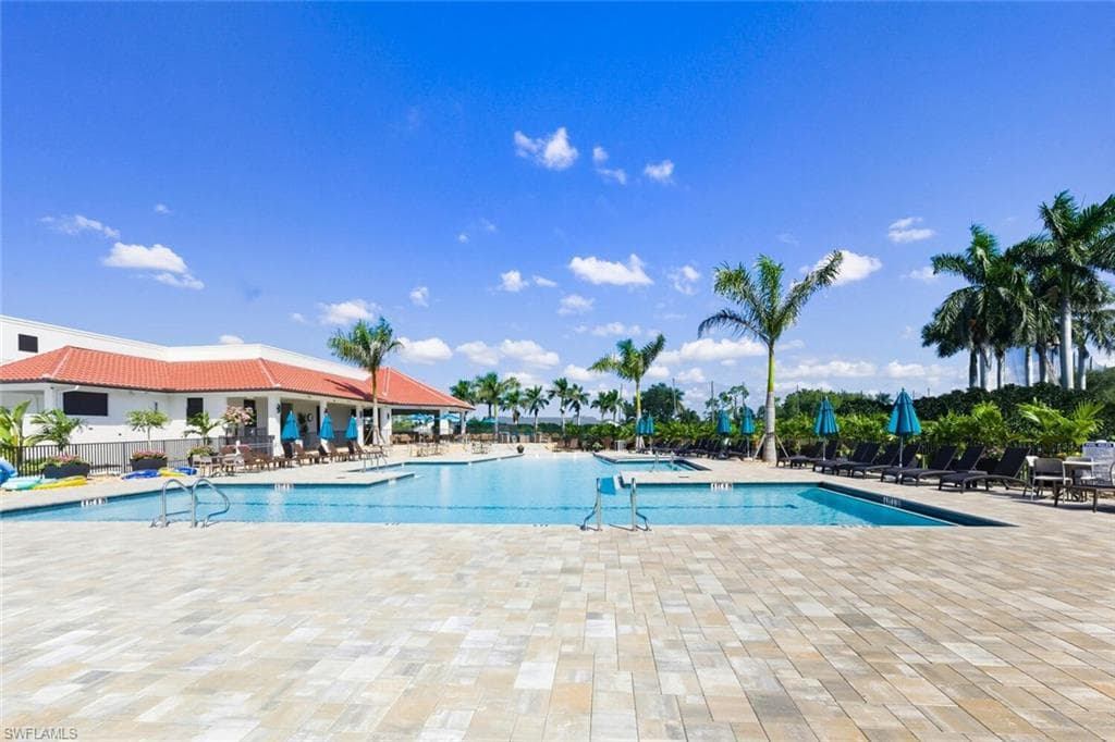Community pool with a patio