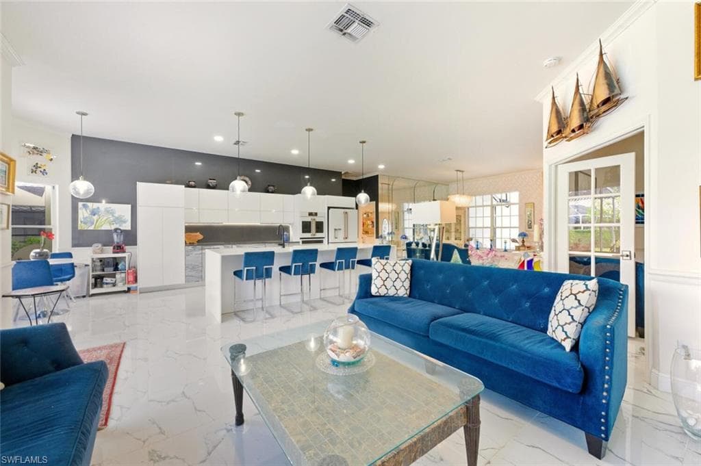 Living area featuring light marble finish floors