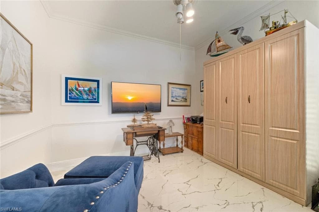Living area featuring crown molding