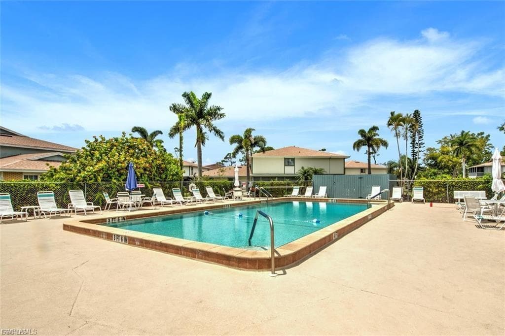 Community pool with a patio