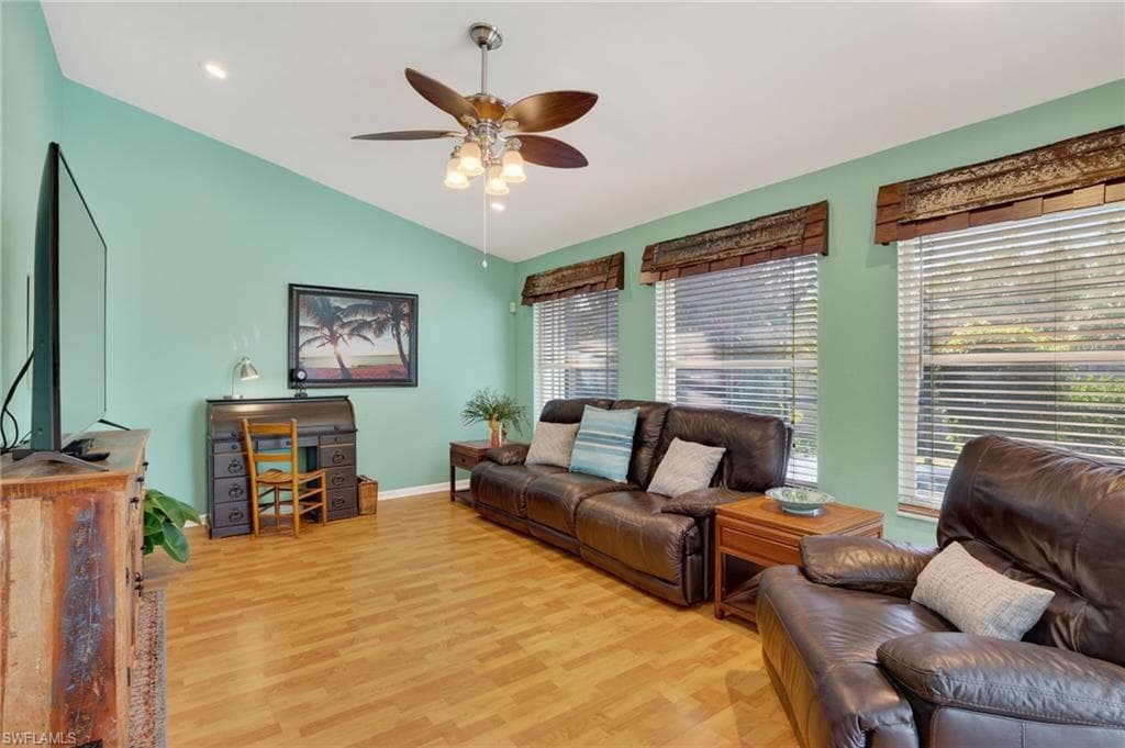 Living area with light wood-type flooring, vaulted ceiling, a ceiling fan, and recessed lighting