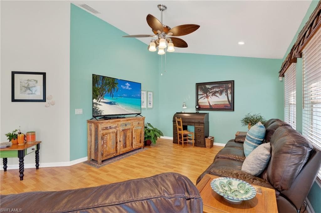 Living area featuring light wood-style floors, ceiling fan, recessed lighting, and lofted ceiling