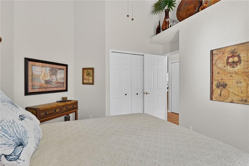 Bedroom with a closet and a high ceiling