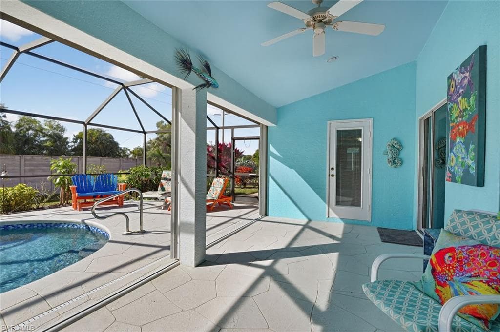 View of pool featuring a patio, glass enclosure, and a sunroom