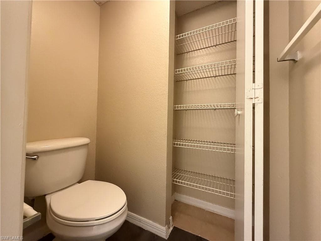 Bathroom with toilet and baseboards