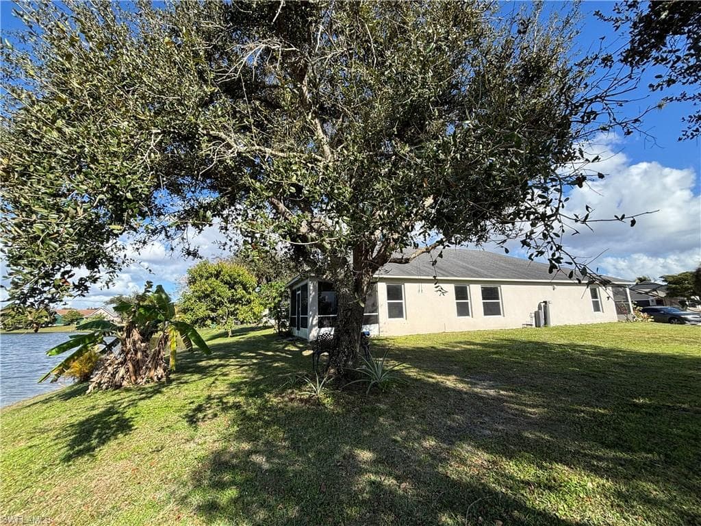 View of grassy yard with a water view