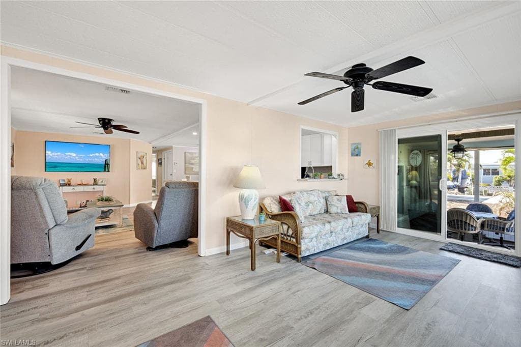 Open gathering space with panoramic windows and easy access to the waterfront outdoor living areas.