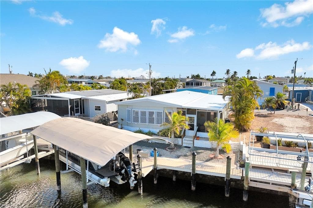 Elevated aerial view showcasing the home's prime canal-front location within Cherry Estates.