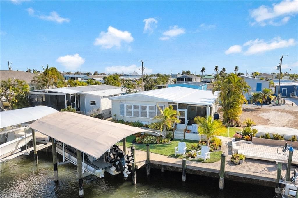 Aerial view highlighting the home's waterfront location, private dock, and direct boating access.