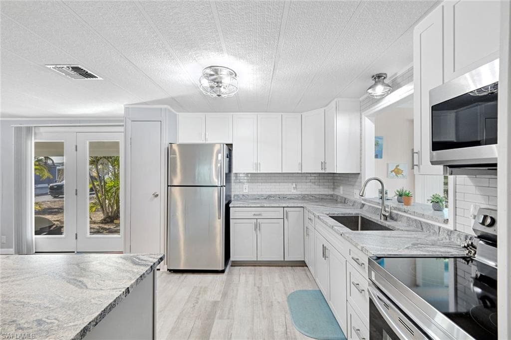Modern kitchen with quartz countertops, stainless steel appliances, soft-close cabinetry, and generous prep space.