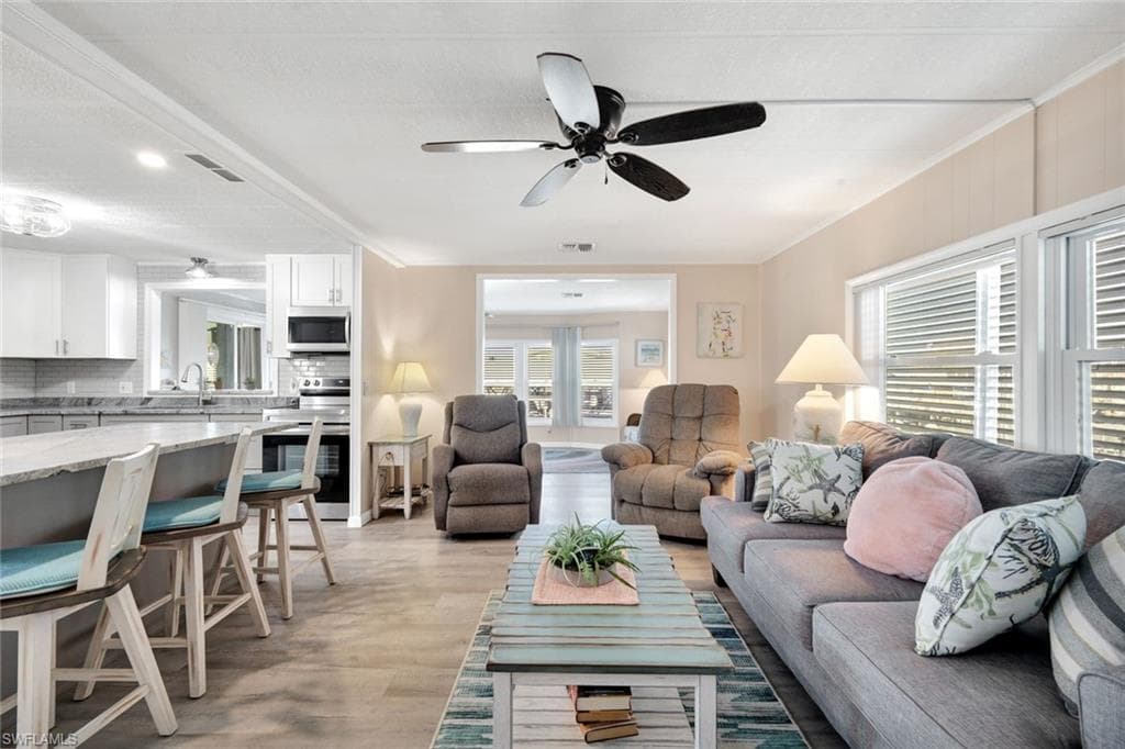 Alternate view of the open living space highlighting the bright coastal interior and expansive layout.
