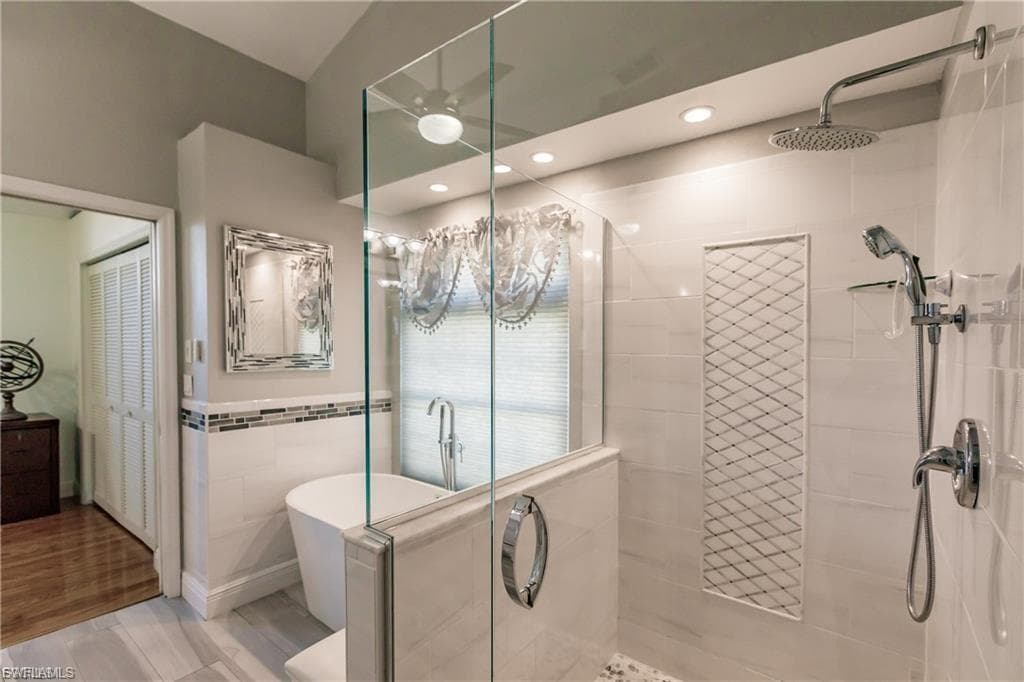 The Luxurious Primary En-Suite Bathroom retreat features both a Rainfall Shower and Elegant Soaker Tub to Calm Your Soul.