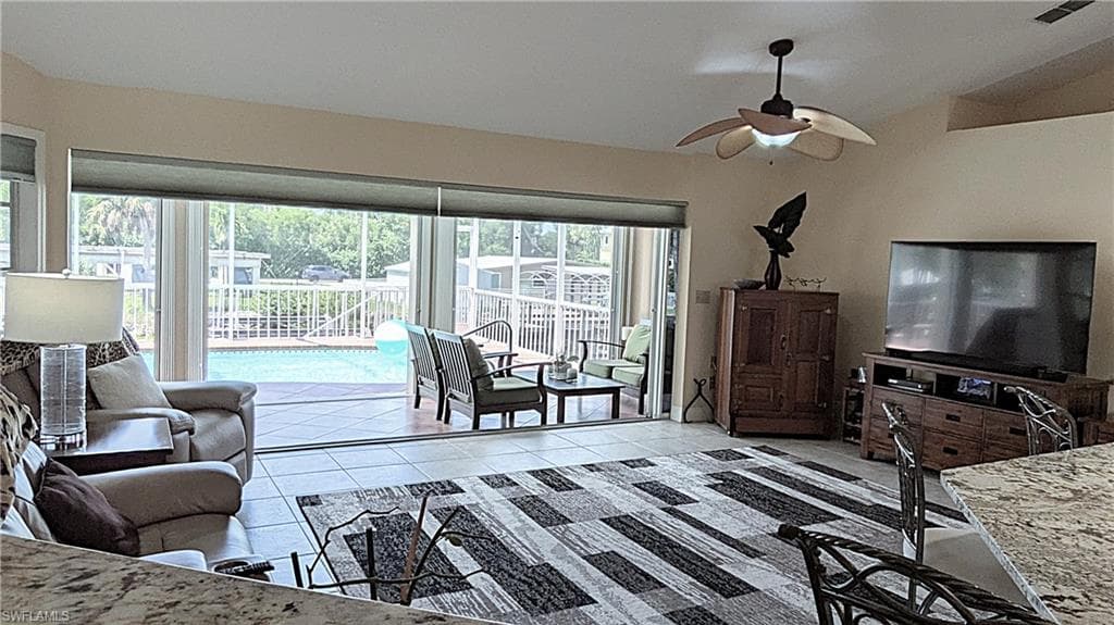 The Heart of the Home: The Family Room features QUADRUPLE Pocketing Sliding Doors and Custom Blinds