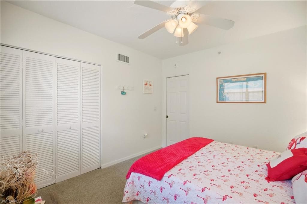 The carpeted bedroom offers plenty of closet space.