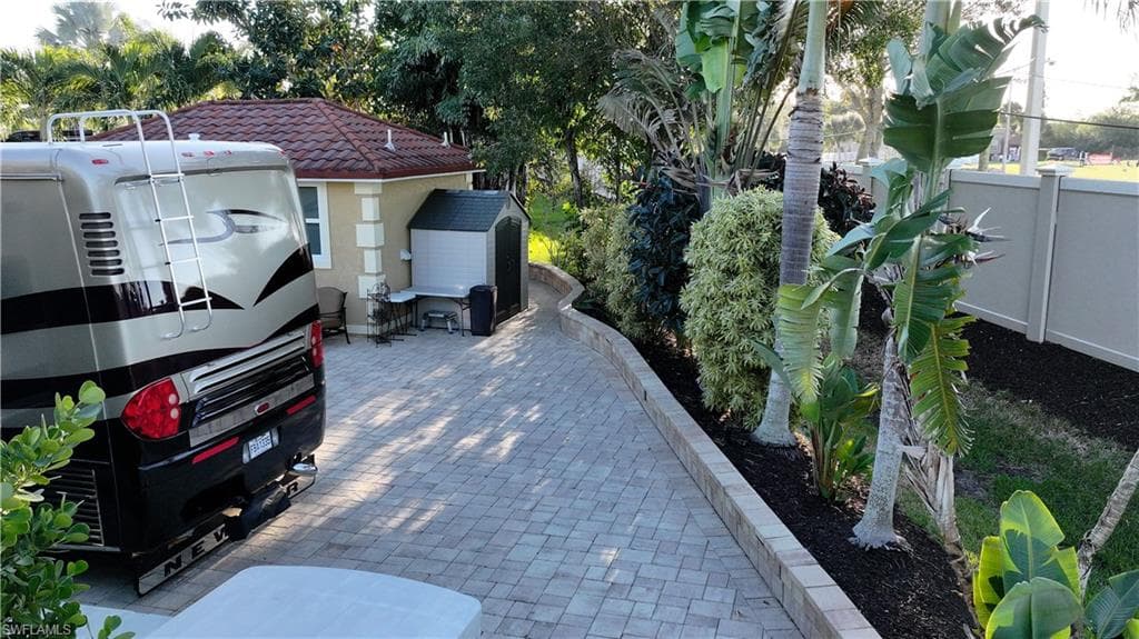 View of parking featuring a shed