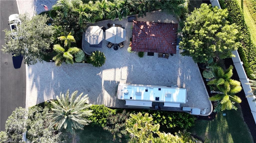 Aerial view of property and surrounding area featuring a pool