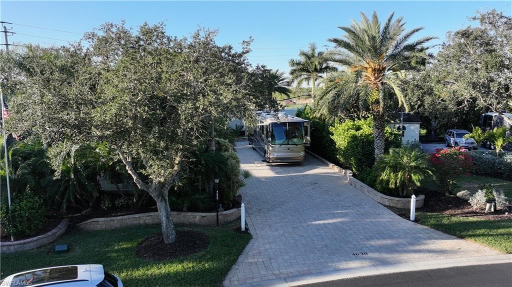 View of parking featuring decorative driveway