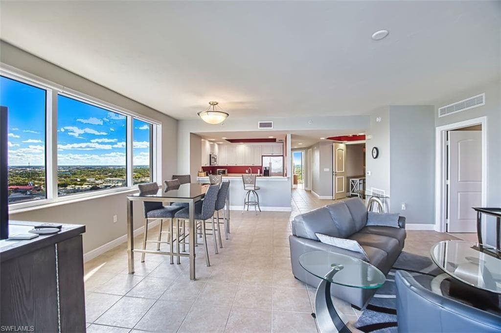 Dining room featuring light tile patterned flooring and baseboards