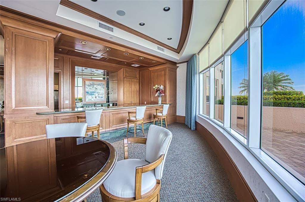 Bar with brown cabinetry and light countertops
