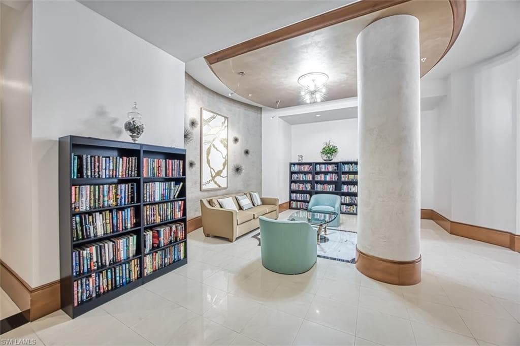 Living area featuring wall of books