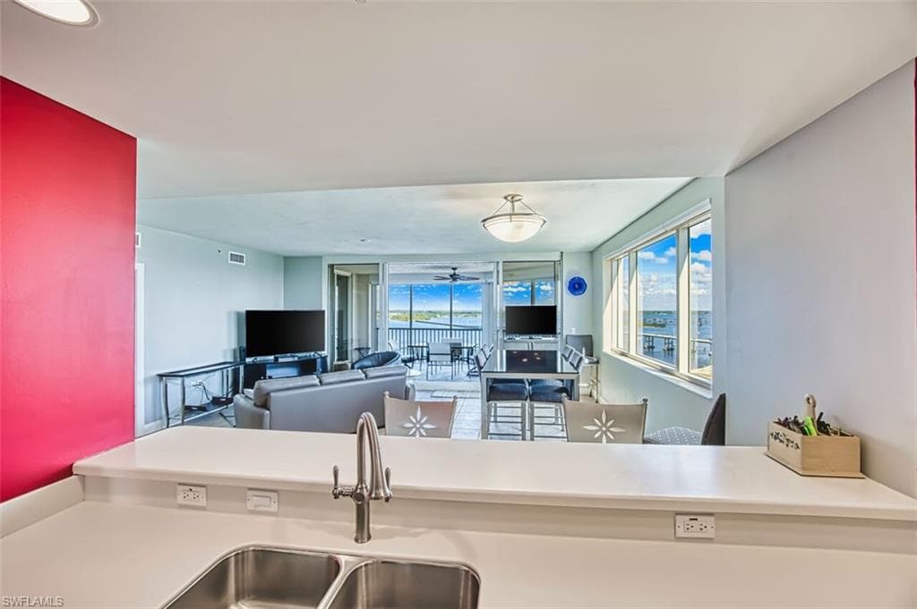 Kitchen with light countertops and a ceiling fan