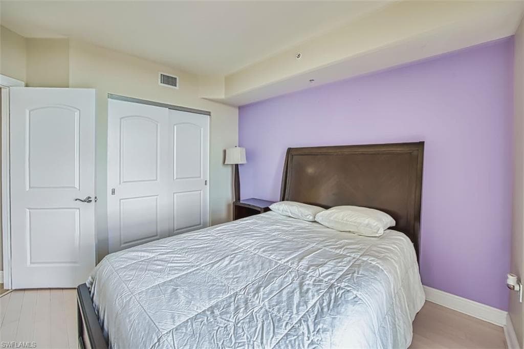 Bedroom with a closet and light wood-style floors
