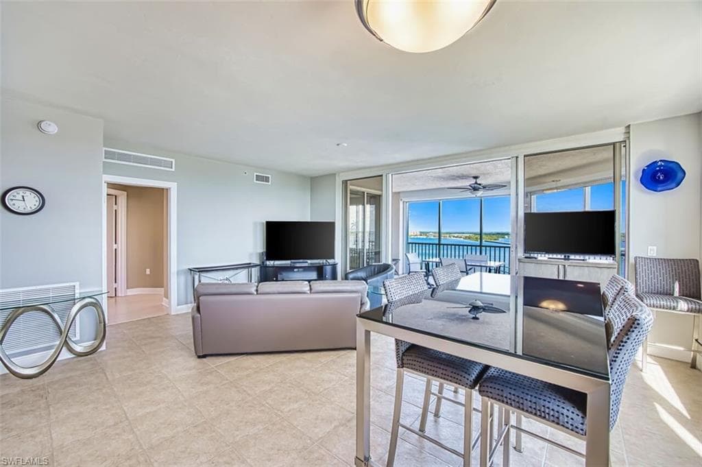 Living area with floor to ceiling windows and baseboards