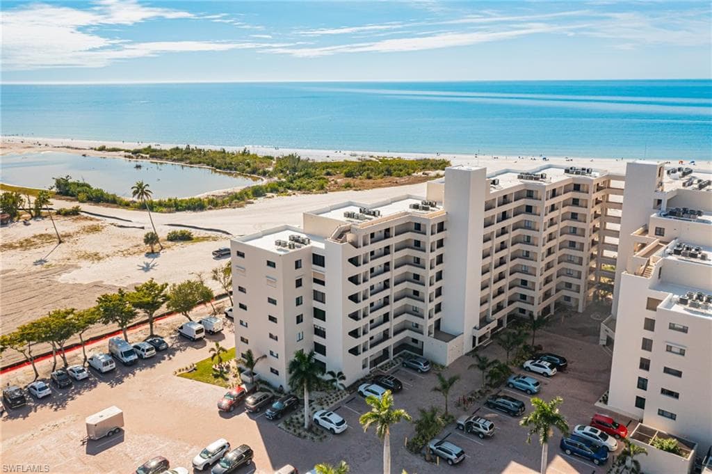 Drone / aerial view of apartment complex / building and unending shoreline
