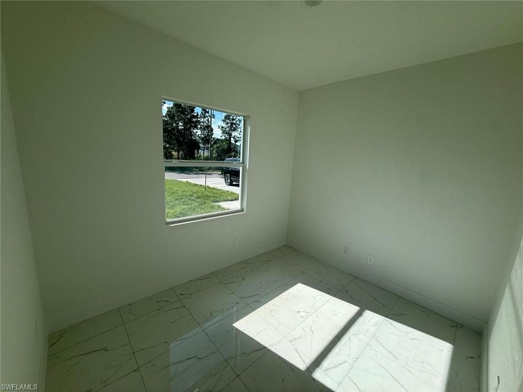 Unfurnished room featuring light marble finish flooring