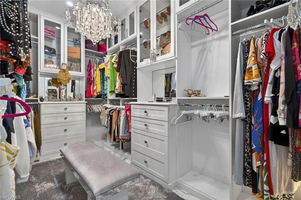 Walk in closet with a chandelier