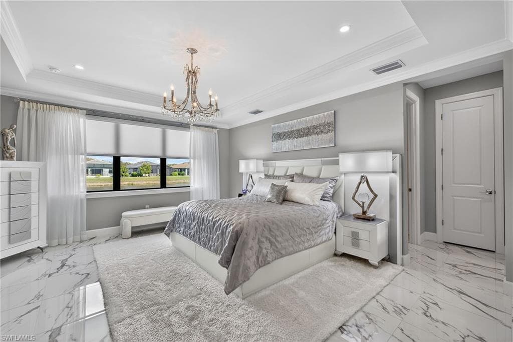 Bedroom with crown molding, a raised ceiling, a chandelier, and recessed lighting